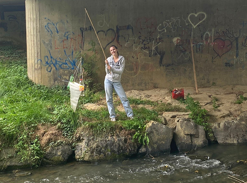 Schülerin angelt Plastik aus dem Fluss